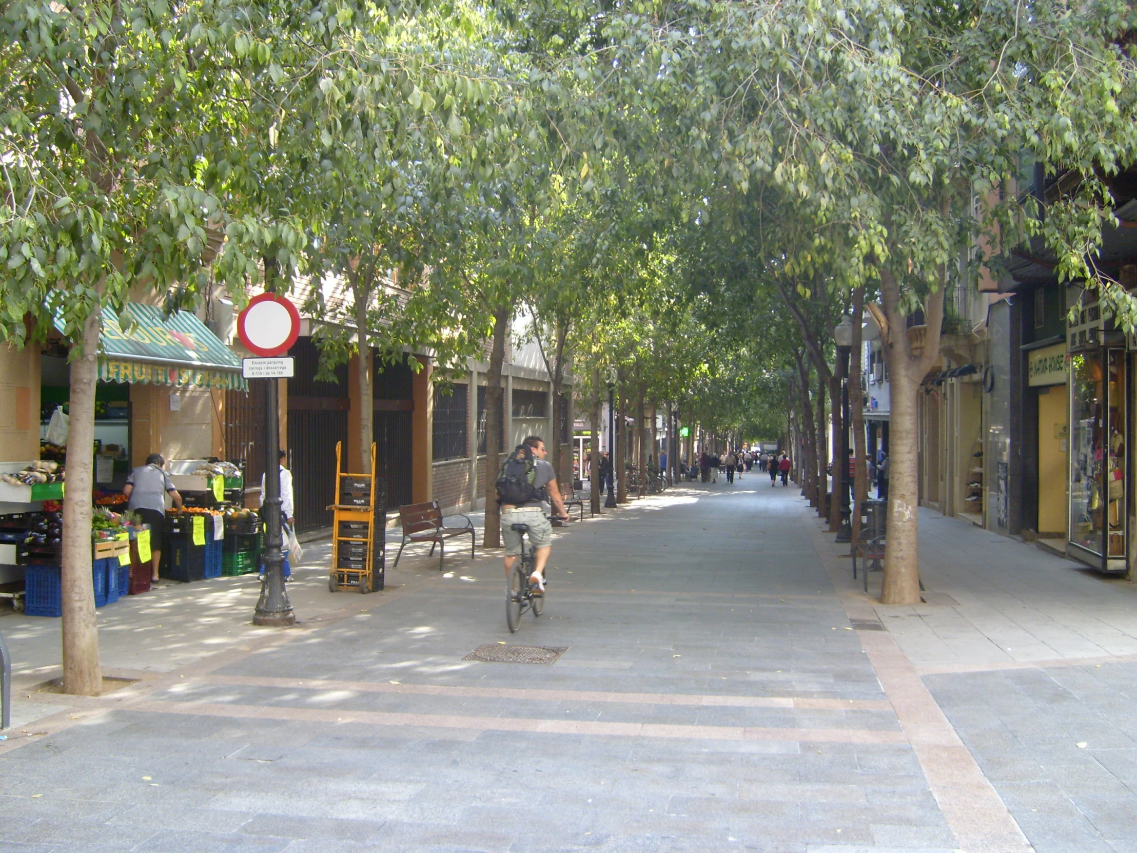 a man riding a bike down the middle of a road