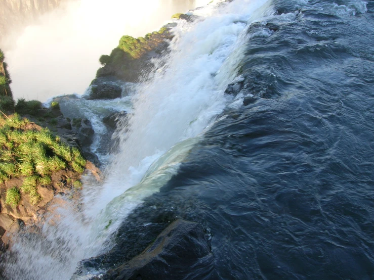 this waterfall is so high it looks over the water