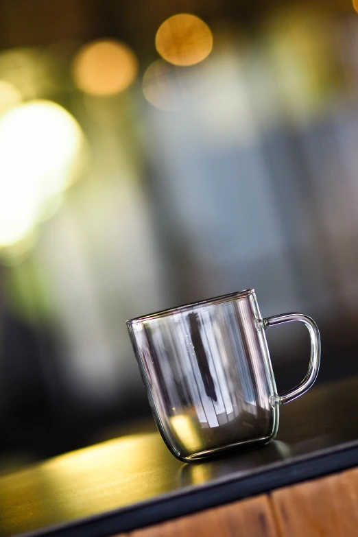 a glass cup sitting on top of a table