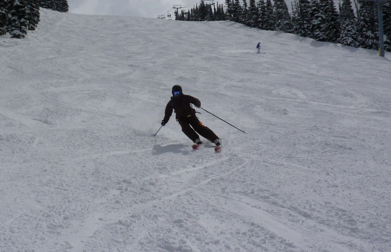 a person skiing on the snow covered slopes