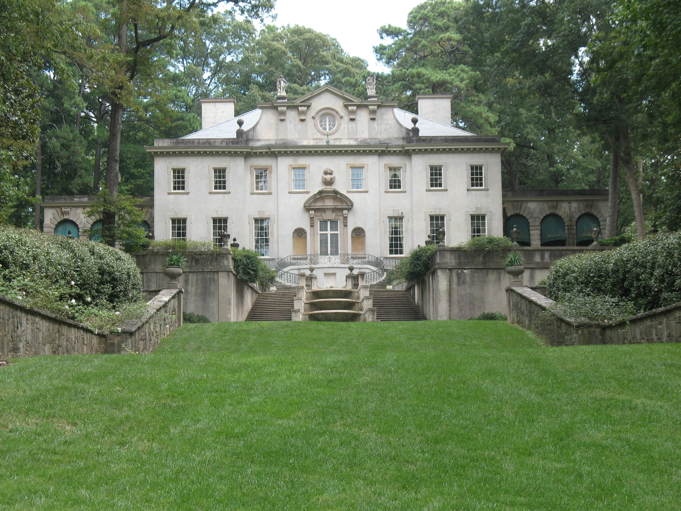 a mansion with a lawn on the side of it