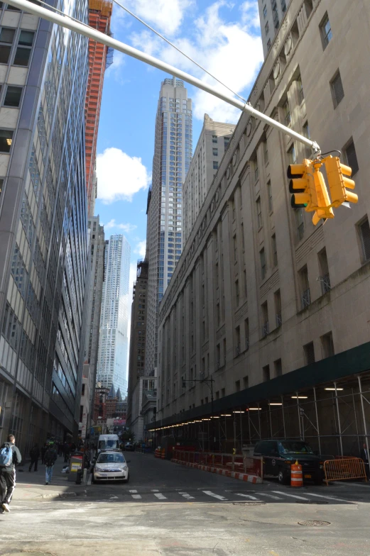 a car is driving on a city street between two tall buildings