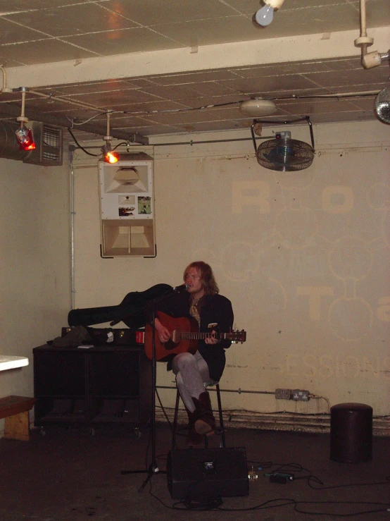 a person is playing an acoustic instrument in a room