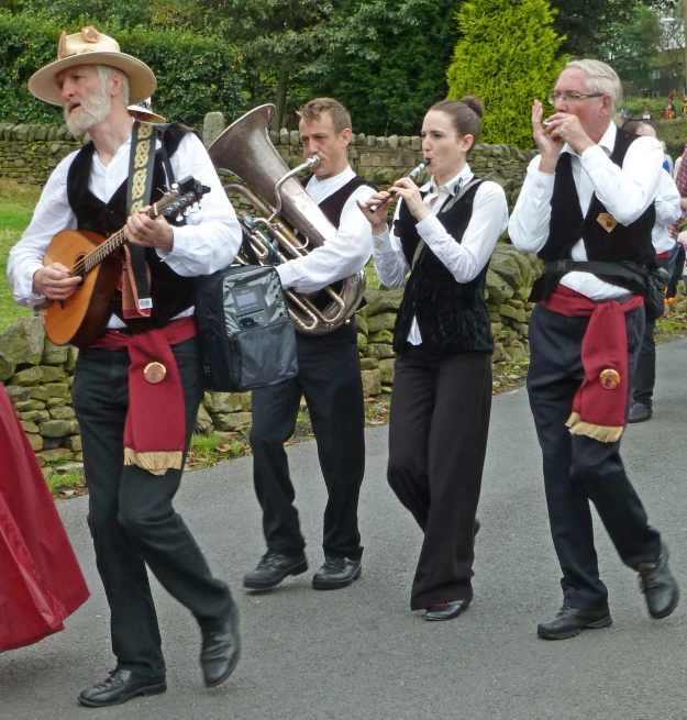 people are playing instruments in their dresses on the street