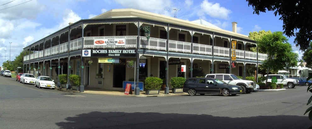 an intersection with cars and a building in the distance