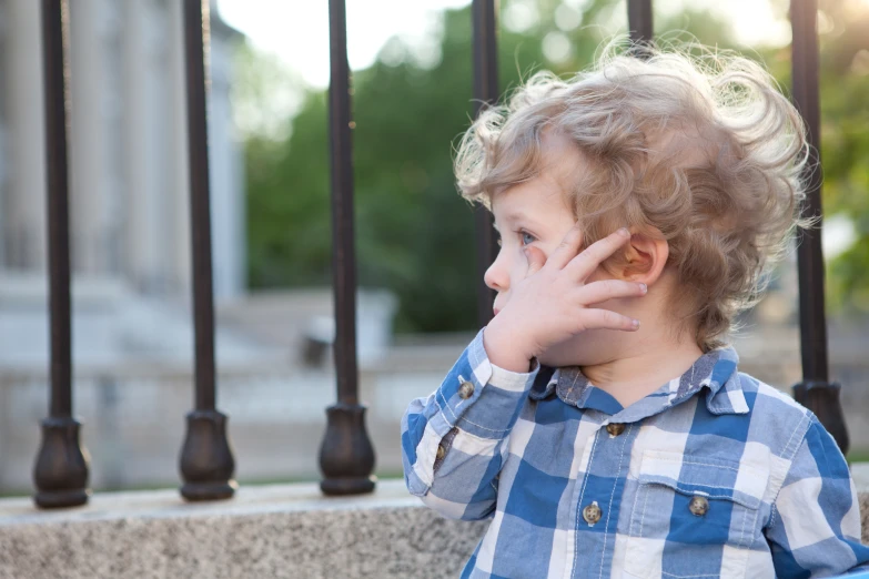 a small boy that is standing near a wall