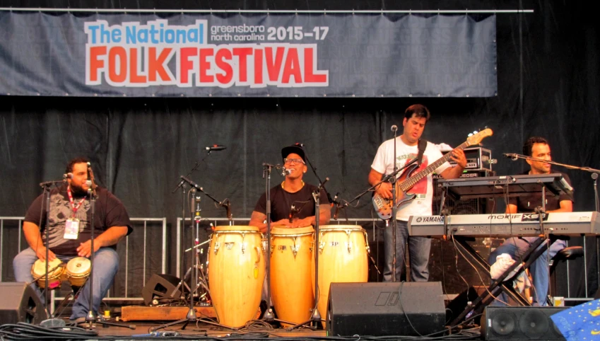 a band performing on a stage with drums