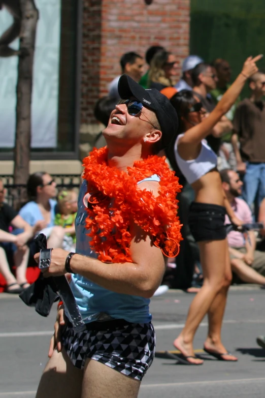 a young man wearing an orange hula is in front of a crowd