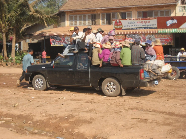 several people in the back of a pickup truck