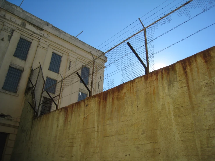 a building behind a barbed wire fence