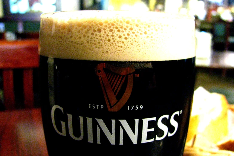 closeup of a glass of beer sitting on a table