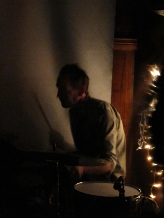 a man standing in a room with a guitar