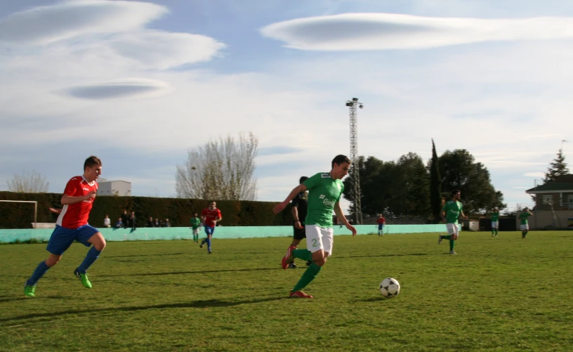 soccer players are playing on the field near each other