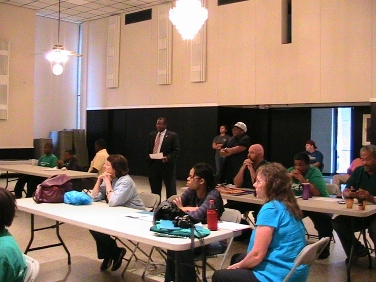 a group of people sitting at tables inside of a room