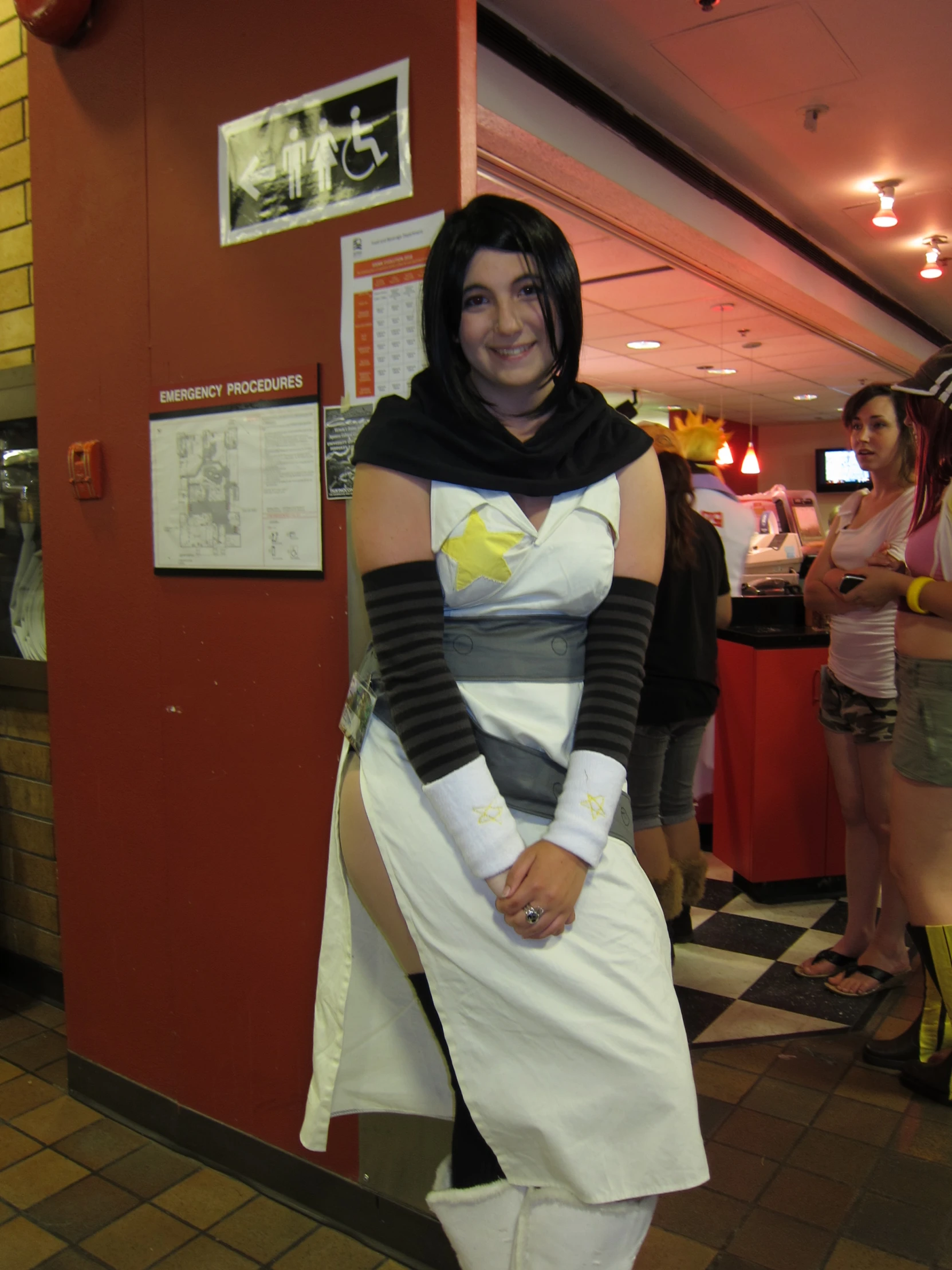 a woman with a star trek outfit stands in a diner wearing her costume