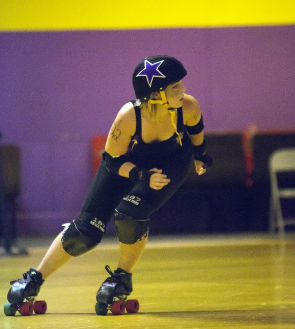 a man riding on top of roller skates down a wood floor