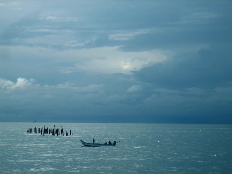 some people standing in a boat near the sea