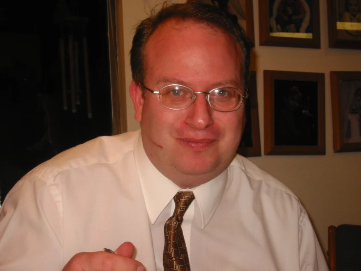 a close up po of a man in glasses with a tie