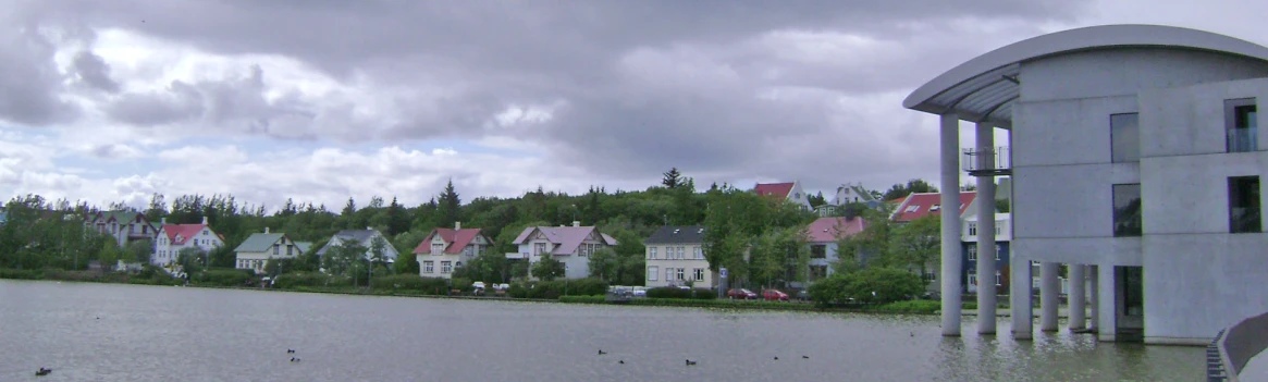 the view of a lake with houses along it