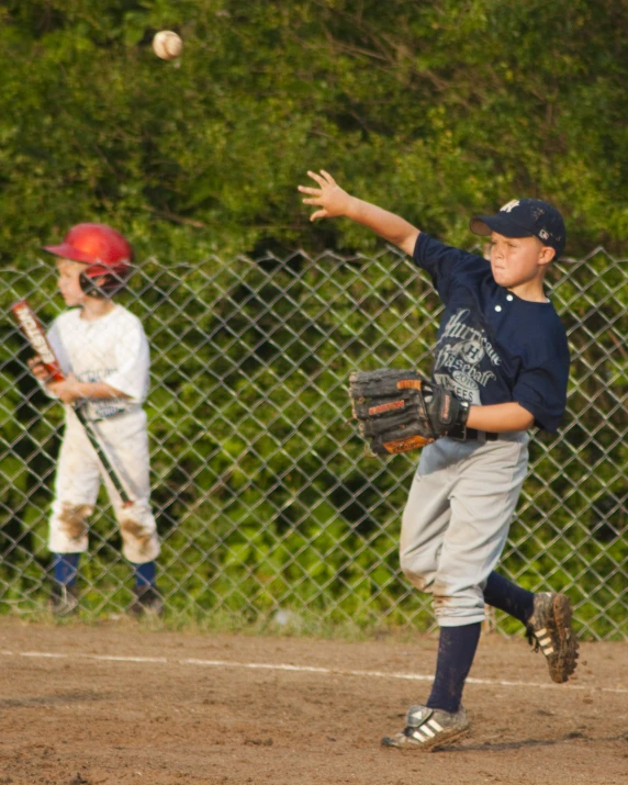 a  who is throwing a ball to another person