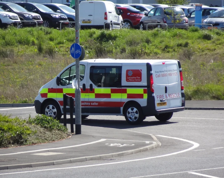 a van driving down the road past a sign