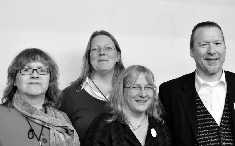 three women and a man posing for a picture