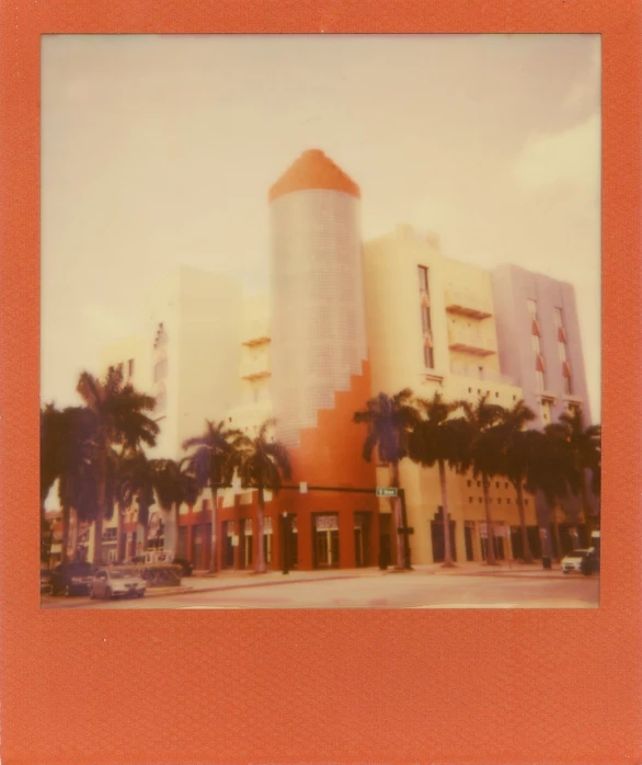 a tall yellow building sitting on top of a road