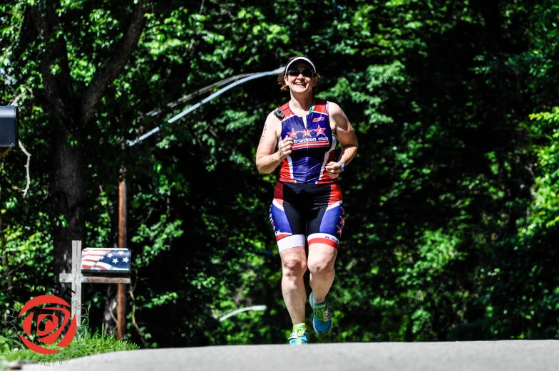 there is a male wearing a blue and red bib running