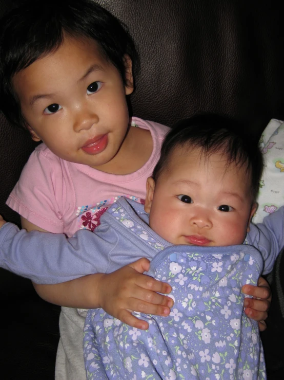 two children that are playing together in some cloth