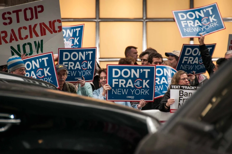 group of people with political signs behind them