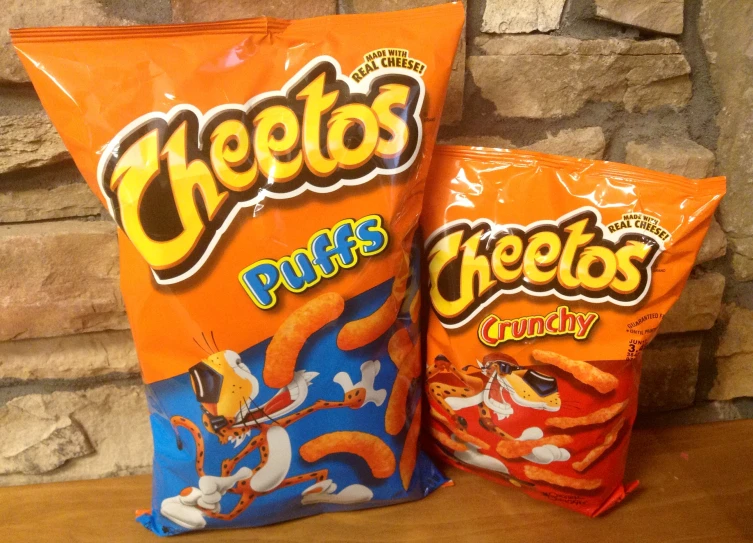 two bags of cheetos are sitting on a table