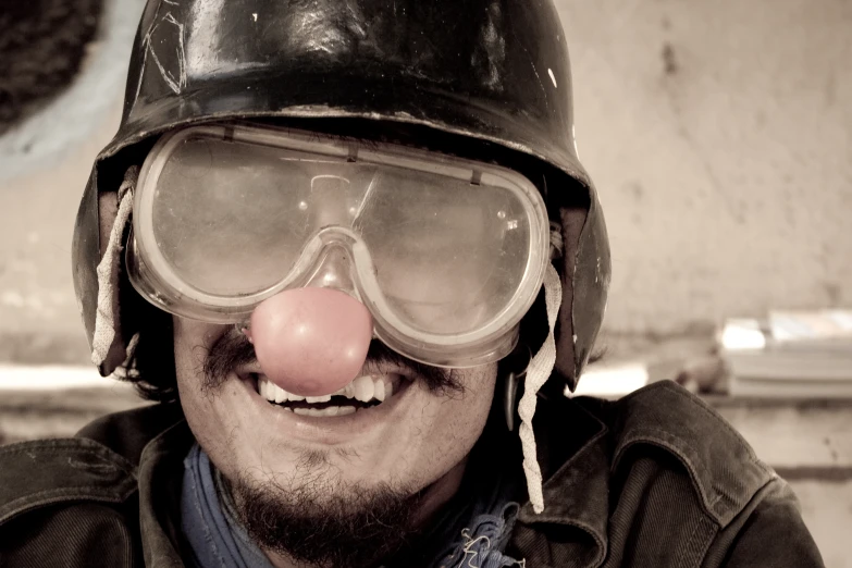 a man with a nose wearing a helmet and goggles