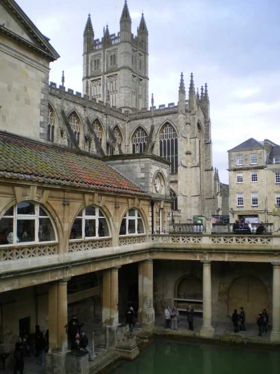 a group of people outside an old stone building