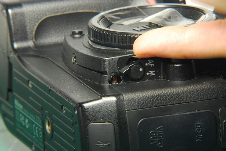 close up of someone using a camera in a po shop