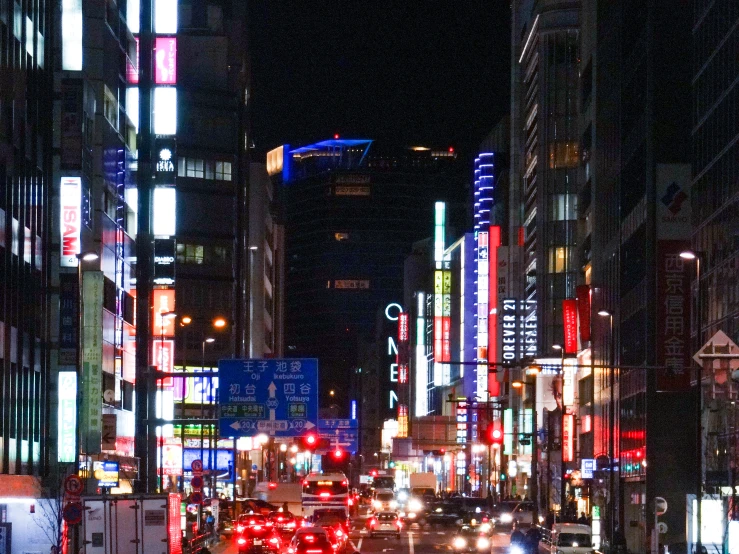 a busy city street with many lit up buildings