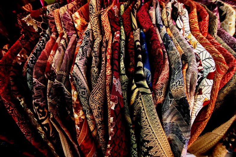 a pile of scarves displayed on wooden floor