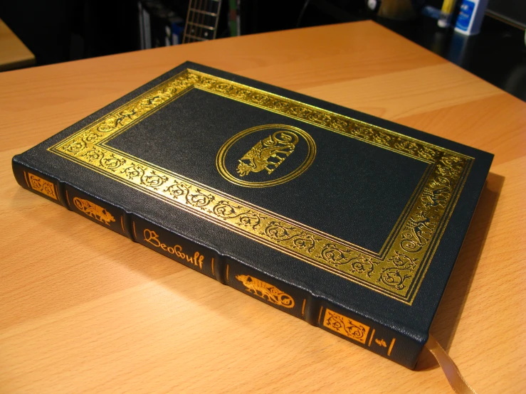an image of a black book on a wooden table