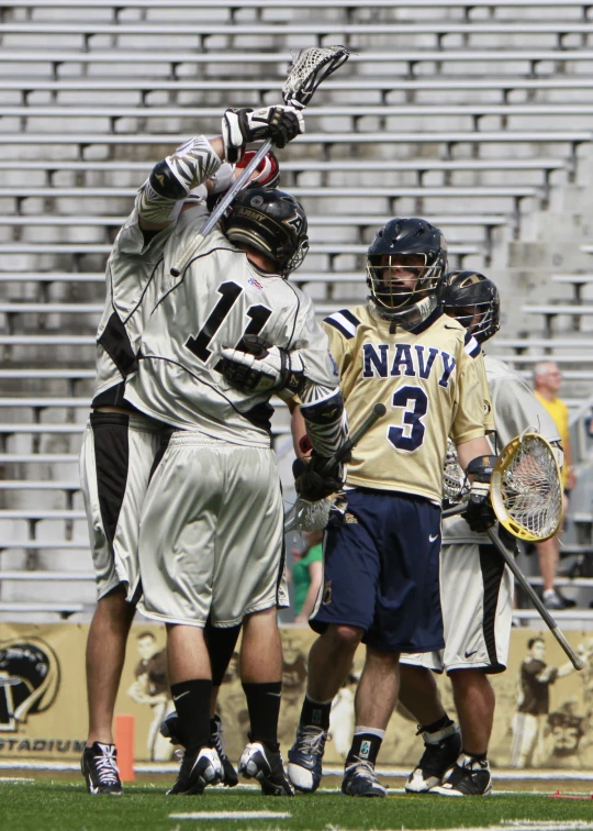 two lacrosse players are playing on a field