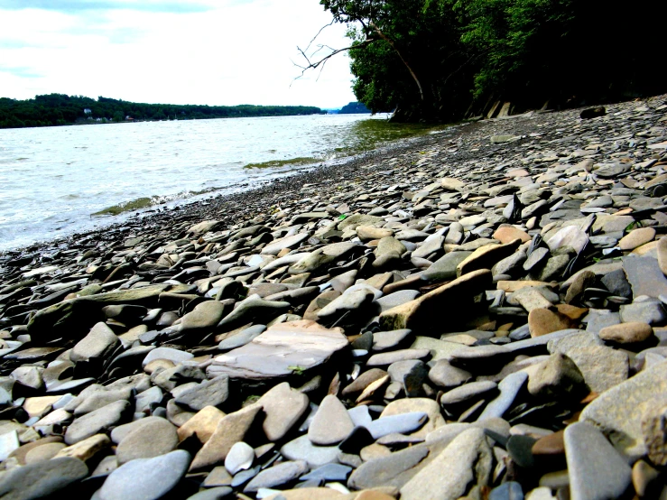 the stone beach is next to some water