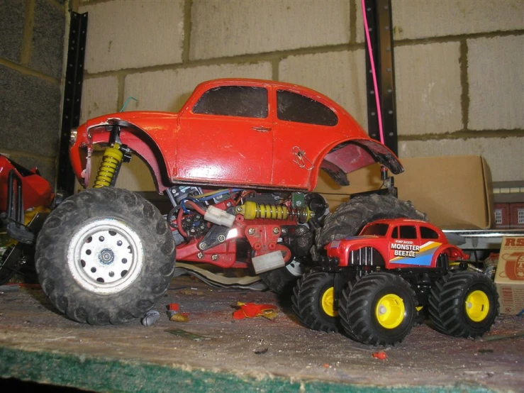 a group of four toy trucks with big tires on display