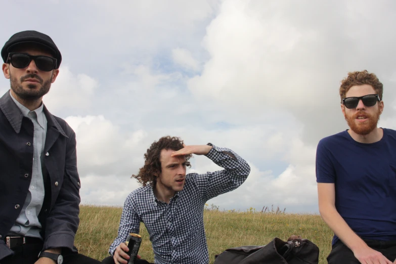 a couple of men standing in a field