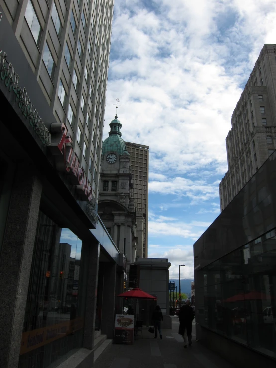 some buildings and a red umbrella on a cloudy day