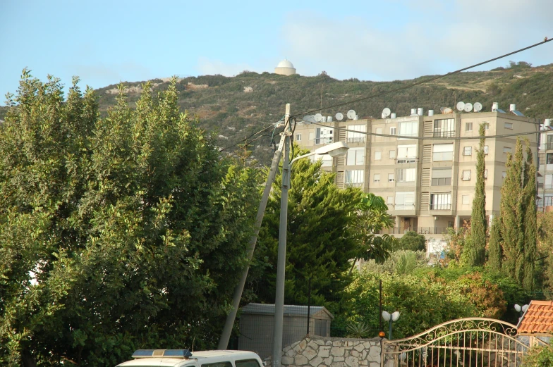 a parking lot with a van on it next to a tall building