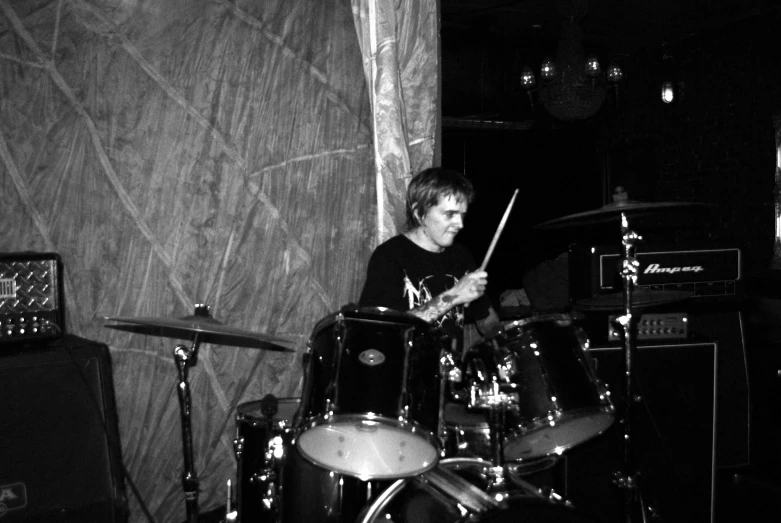 a man that is sitting in front of drums