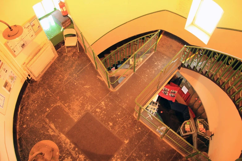 an overhead view of a staircase and table in a dining room