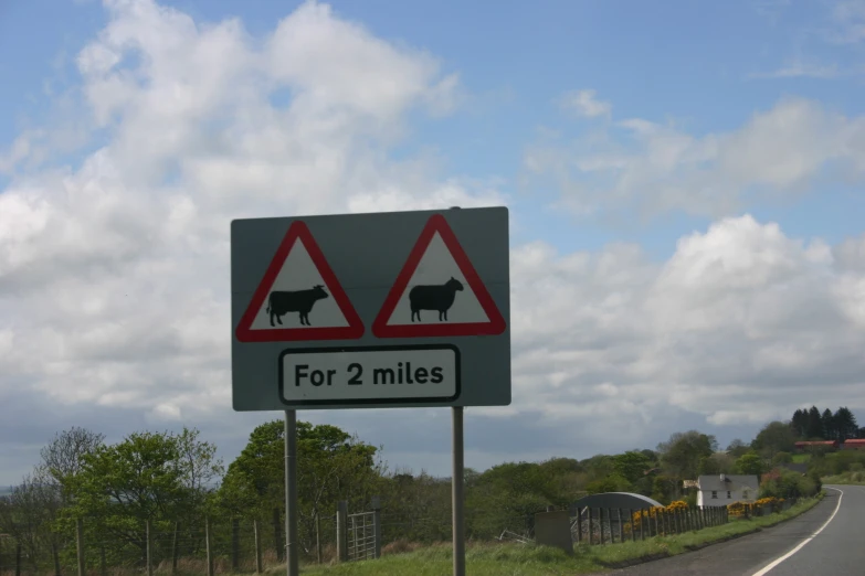 a street sign stating two miles left