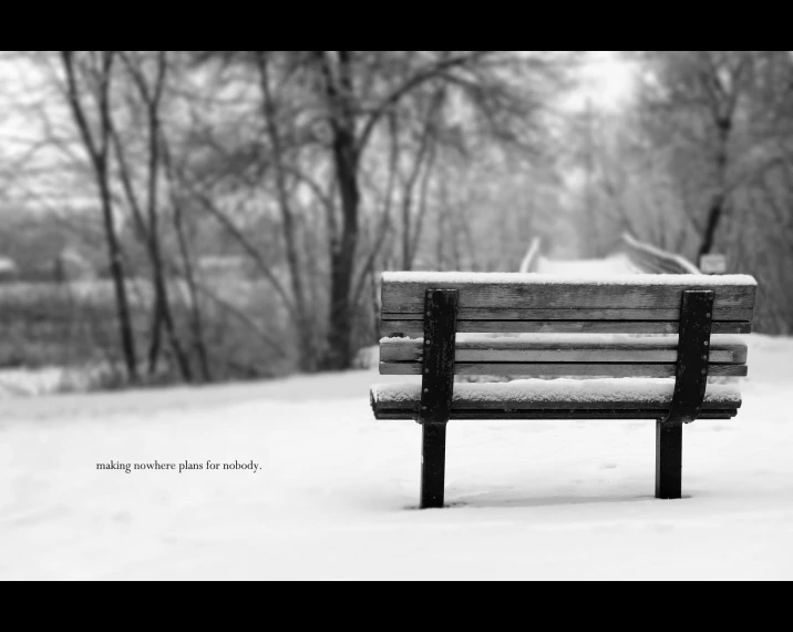 a bench on a snowy day in a park