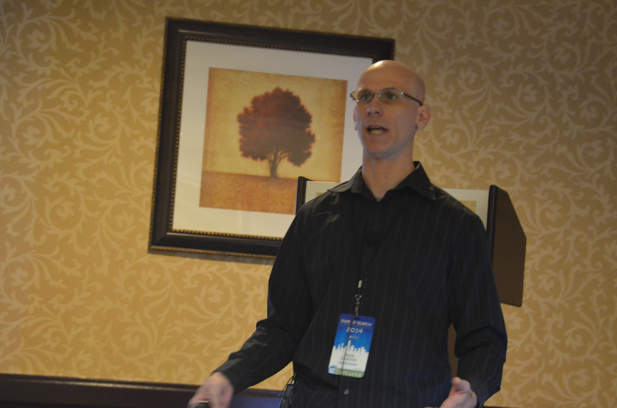 man standing while gesturing in front of a room