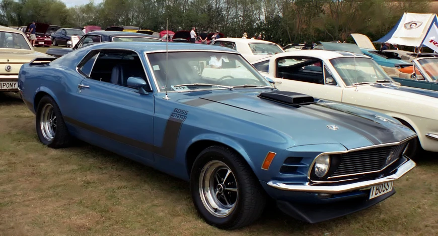 a vintage chevrolet camaro is parked in the grass