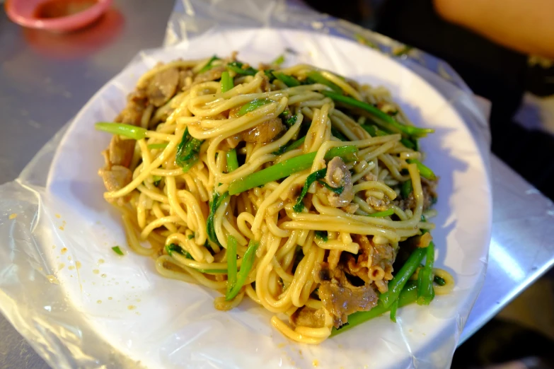 an entree of noodles is prepared on the plate